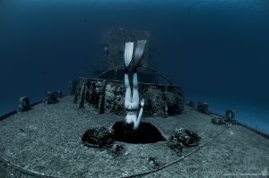 Freediver Valentina Kochian diving the amazing C-52 shipwreck near Cozumel.